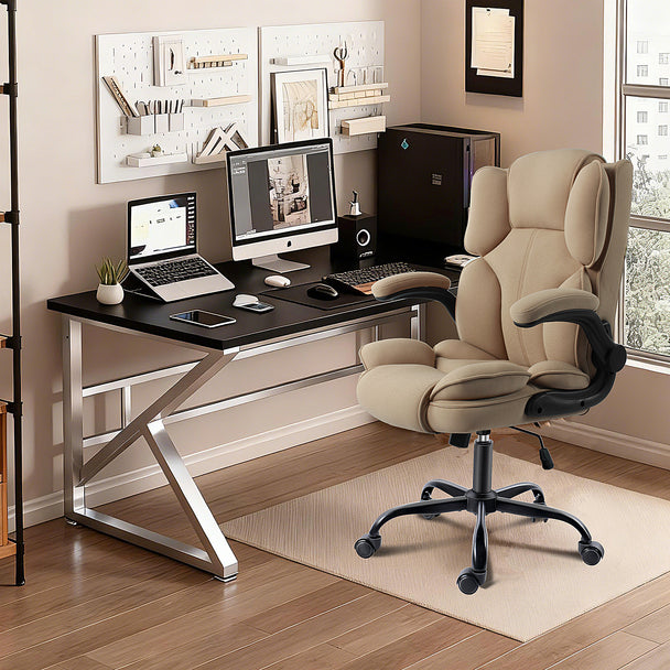 Office workspace with beige ergonomic chair, computer, and organized desk